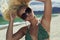Beautiful blond woman in sunglasses on the beach. beauty girl in bikini. summer holidays