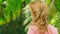 Beautiful blond woman touches her hair in nature. back view. hair treatment concept