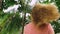 Beautiful blond woman touches her hair in nature. back view. hair treatment concept