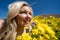 Beautiful blond woman in a yellow wildflower field, looking up at a blue sky in spring. Taken at Carrizo Plain National Monument