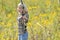 Beautiful blonde archer in field of wildflowers