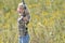 Beautiful blonde archer in field of wildflowers