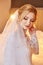 Beautiful blonde bride in the morning in a white wedding dress w