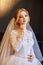 Beautiful blonde bride in the morning in a white wedding dress w