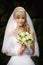 Beautiful blonde bride with wedding bouqet in the hands