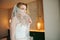 Beautiful blonde bride in white trousers, top and veil.