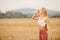 Beautiful blonde drinks water after yoga exercise in park from sports bottle