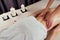 Beautiful blonde female relaxation in spa salon with professional masseur shoulder body next to the candle fire