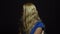 Beautiful Blonde Girl in Blue Dress is Angry and Furious in Studio with Black Background.