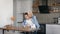 Beautiful Blonde gives her boyfriend a birthday present. Joyful young people at home in the kitchen.