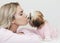 Beautiful blonde kisses shih tzu, in pink clothes, cute puppy