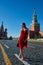 Beautiful blonde lady in red dress on Red Square