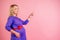 Beautiful blonde pregnant woman in a dress with red satin bow on the belly baby bump dream and point finger up in the