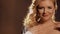 Beautiful blonde with red lips sensually touches her neck and face