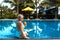 Beautiful blonde relaxes sunbathes near the pool on vacation