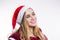 Beautiful blonde Santa woman in red hat smiling and laughing on white background