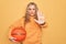 Beautiful blonde sportswoman doing sport holding basketball ball over yellow background with open hand doing stop sign with