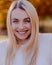 Beautiful Blonde Woman Close-Up Portrait in Fall Setting Outside Autumn Elegance