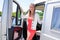 Beautiful blonde woman driver front of motor rv camper van home campervan in vanlife concept