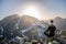 Beautiful blonde woman enjoys reaching the summit in the Slovak Tatras and looks at the Gerlach mountain.