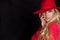 Beautiful blonde woman in a red hat, red jacket suit and red tempting lips