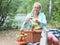 A beautiful blonde woman with a smile prepares a fruit barbecue.