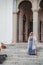 Beautiful blonde woman stands on the steps of the Monsoon Palace in Udaipur India