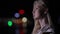 Beautiful blonde woman touch her long hair in night city
