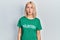 Beautiful blonde woman wearing volunteer t shirt making fish face with lips, crazy and comical gesture