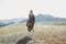 Beautiful blonde young woman traveler in dress from back on road, trip to the mountains, Altai