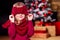 Beautiful blone little girl in the winter warm hat and scarf feeling happy and wish a good things on a Christmas