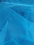 Beautiful blue background of transparent veil with several layers that create depth, airiness. Creative sky blue backdrop