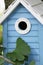 Beautiful blue birdhouse in the garden