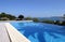 Beautiful blue fresh infinity swimming pool in a villa in sunny Spain with sea views