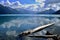 Beautiful blue Garibaldi Lake surrounded by trees and mountains covered with glacier.