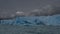 The beautiful blue glacier of Perito Moreno. Chunks of ice that have broken off from the wall are floating