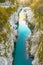 Beautiful blue and green colored, crystal clear Soca river flowing and passing through narrow rock canyon