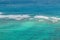 Beautiful blue green turquoise teal shallow tropical water with waves breaking on a coral reef on Oahu, Hawaii, USA