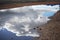 The beautiful blue holy lake clearly reflects the snowy mountains and the sky on the shore