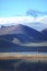 The beautiful blue holy lake clearly reflects the snowy mountains and the sky on the shore