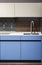 Beautiful blue kitchen unit, kitchen faucet, wooden apron in the kitchen. Modern minimalistic kitchen design
