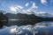 Beautiful blue lake with surrounding mountains reflecting back