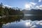 Beautiful blue lake with surrounding mountains reflecting back