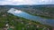 A beautiful blue lake. View from the drone Clip. A small lake next to which are green sunny trees, behind the forest and