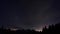 Beautiful blue night sky with the Milky Way in a mountain landscape.Silhouette of trees, mountains