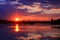 Beautiful blue and orange sunset on the water with symmetry of colorful clouds cumulonimbus