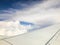 Beautiful of Blue sky above the clouds with wings of the airplane. View of Looking through the window of airplane