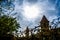 Beautiful blue sky with clouds above the brick towers. Bright sunlight