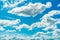 Beautiful blue sky and white cumulus clouds abstract background. Cloudscape background. Blue sky and fluffy white clouds on sunny