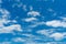 Beautiful blue sky and white cumulus clouds abstract background. Cloudscape background. Blue sky and fluffy white clouds on sunny